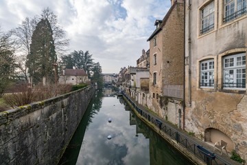 Fototapeta na wymiar Ancient French classic medieval town with river in front, Dole, Burgundy, France