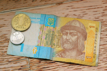Ukrainian money. One hryvnia paper note and a metal coin.