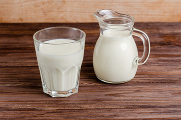 Homemade fermented beverage in a glass of kefir on a wooden background
