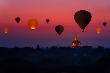 Sunrise many hot air balloon in Bagan, Myanmar. Bagan is an ancient with many pagoda of historic...