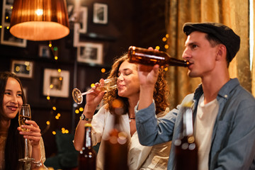 Happy group of friends at the bar having drinks.