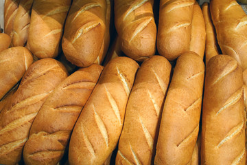 Freshly baked loaves as a background  food. Assortment of baked bread