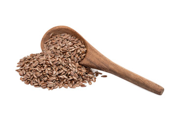 Linseeds or flax seed on a tilted brown wooden spoon with spill and handle obliquely from right isolated on white background