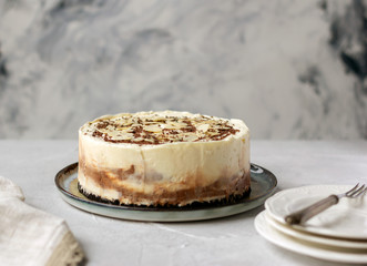 Homemade raw chocolate cheesecake or mousse cake decorated with chocolate morsels and almond flakes. Copy space