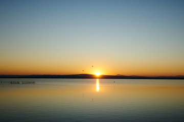 Fototapeta na wymiar orange sunset on a lake 
