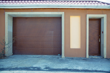 Shutter door or roller door and concrete floor outside .White Automatic shutters in a house . gates in the garage . Automatic Electric Roll-up Gate Or Push-up Door In The Modern Building  .