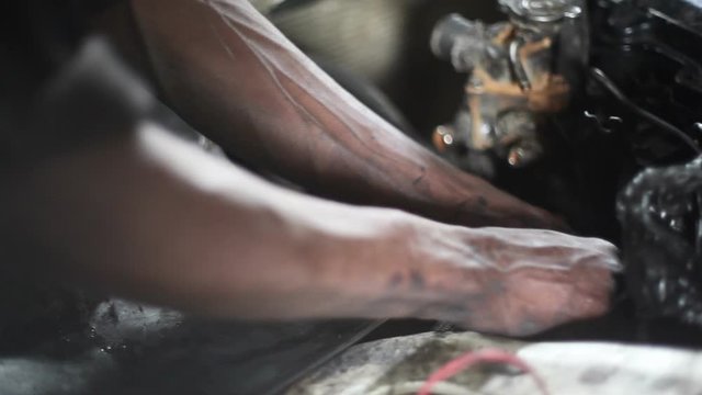 Dirty hands fix car engine, garage mechanic, Nairobi, Kenya, Africa