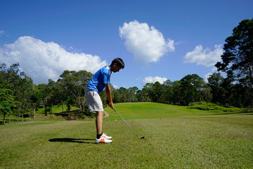 Golfer playing golf in beautiful golf course in the evening golf course with sunshine in thailand.