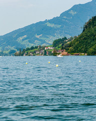 Fototapeta na wymiar Lucerne, Switzerland. Enchanting city on the homonymous lake and on the Reuss river, protected by the Alpine mountains, it is famous for holidays immersed in unspoiled nature. View of the lake.
