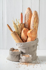 Crunchy french baguettes for breakfast in linen bag