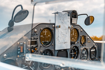 Cockpit of an Extra 300 L aerobatic monoplane with pilots for stunt figues notes pinned on the...