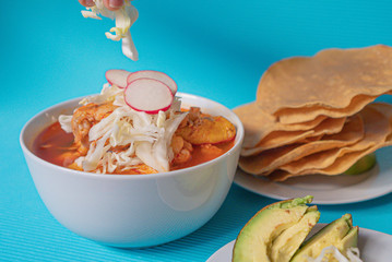 Delicious typical Mexican red Mexican pozole with tostadas