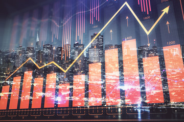 Financial graph on night city scape with tall buildings background double exposure. Analysis concept.