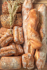 Mix of homemade buns and baguettes freshly baked in bakery