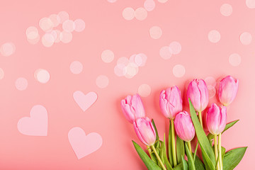 View from above pink tulips, hearts and confetti. Background for womens day, 8 March Valentines day, 14 february. Flat lay style, top view, mockup, template, overhead. Greeting card