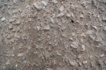 The dim surface of the old road from broken asphalt