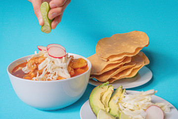 Delicious typical Mexican red Mexican pozole with tostadas