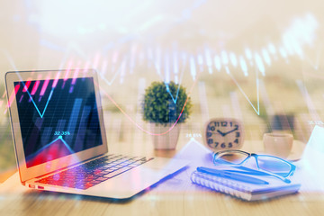 Obraz premium Forex graph hologram on table with computer background. Multi exposure. Concept of financial markets.