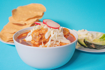 Delicious typical Mexican red Mexican pozole with tostadas