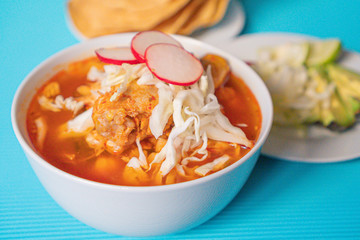 Delicious typical Mexican red Mexican pozole with tostadas