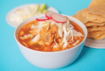 Delicious typical Mexican red Mexican pozole with tostadas