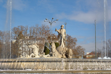 Fountain of Neptune (Fuente de Neptuno). Winter photo of the neoclassical style statue of Neptune and horses at the center of the Canovas del Castillo square in Madrid, Spain.
