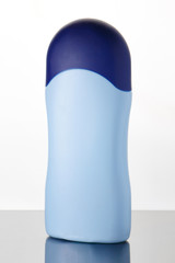 Gently blue cosmetics bottle on a white background.