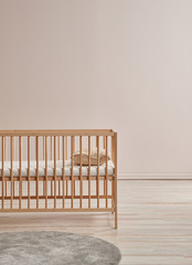 Decorative baby room, crib wooden furniture detail and cabinet style.
