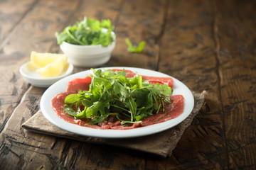 Beef carpaccio with arugula salad