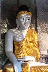 Ornate seated Buddha statue at Shwedagon Paya