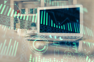 Computer on desktop in office with technology theme hologram. Multi exposure. Tech concept.