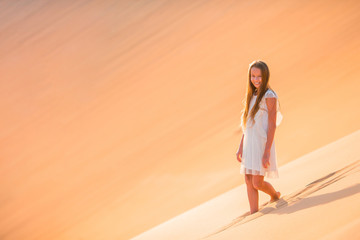 Fototapeta na wymiar Girl among dunes in Rub al-Khali desert in United Arab Emirates