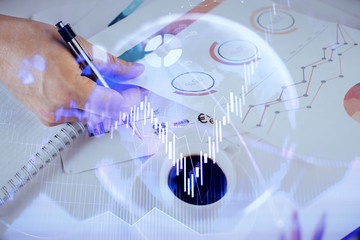 Multi exposure of man planing investment with stock market forex chart.