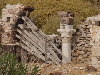 Naklejka premium The ruins of an ancient church, traditional architecture, columns in the historical center of the city of Perissa Santorini island.