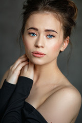Naklejka premium portrait of a young beautiful girl on a neutral background