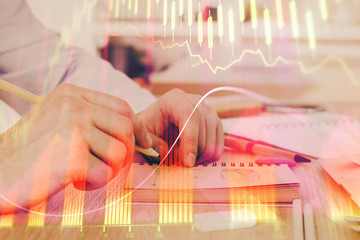 Multi exposure closeup hands with stock market forex graph.