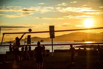 Beach valleyball players during sunset on a beach in Canada Vancouver British Columbia person scoring 
