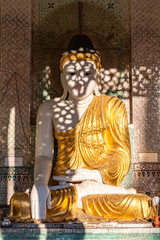 Ornate seated Buddha statue at Shwedagon Pagoda