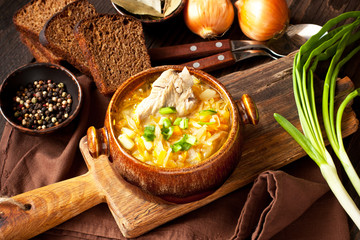 Sauerkraut soup in ceramic bowl on wooden table