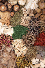 Chinese herbs used in traditional ancient herbal medicine forming a background. 