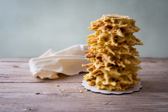 Bankuchenas - traditional regional cake from Lithuania. Delicious tree cake is prepared by hand, egg layers are baked by open fire.  Whole cake on a wooden table