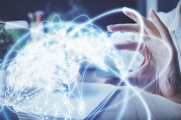 International business hologram over woman's hands taking notes background. Concept of success. Double exposure