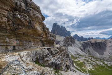 Path along the Rocky landscape in the Dolomites on a sunny day