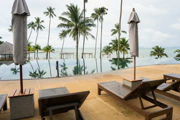 two sun loungers by the sea near the pool in Thailand