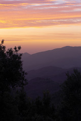 Orange clouds on a mountain landscape sunset sky