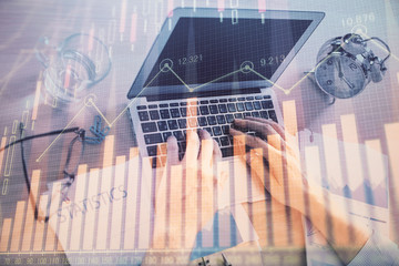 Multi exposure of forex graph with man working on computer on background. Concept of market analysis.