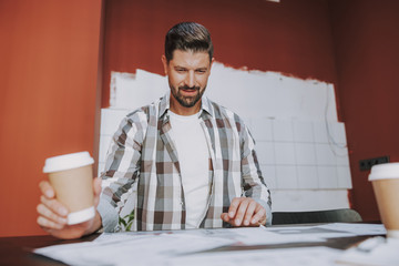 Smiling designer is sitting at the desk