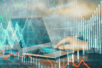 Double exposure of stock market graph with man working on laptop on background. Concept of financial analysis.
