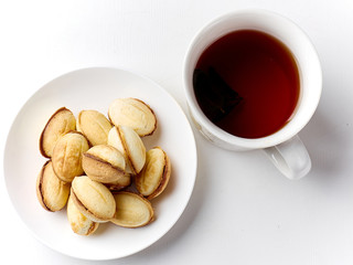delicious walnut shaped shortbread sandwich cookies filled with sweet condensed milk and a mug of tea