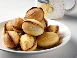 delicious walnut shaped shortbread sandwich cookies filled with sweet condensed milk and a mug of tea